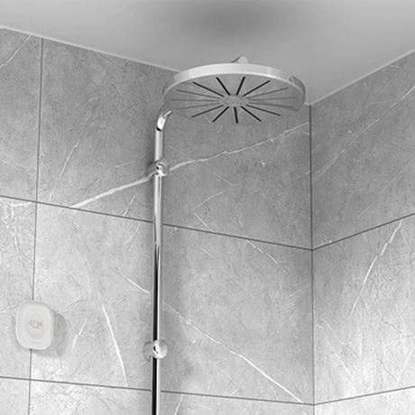 Aguardio Shower Sensor next to a silver showerhead. 