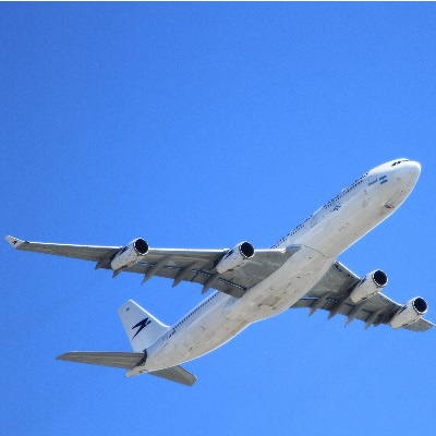 Airplane in flight against blue sky