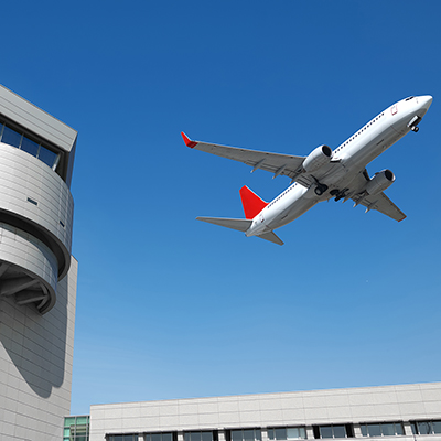 Airplane above air tower