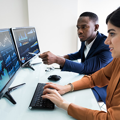 Guy in a suit using a touch board to track a chart