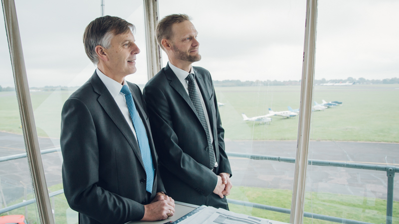 Johan Klintberg and Sir Peter Gresgon view the airfield