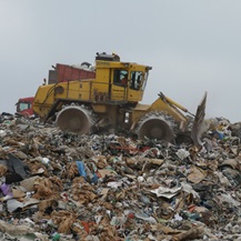 Close JCB on landfill rubbish