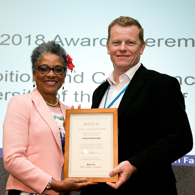 Peaches Golding and David Denyer holding a certificate