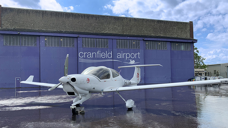 small plane outside hangar