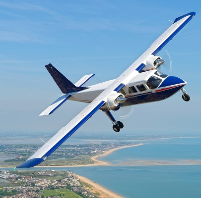 Islander aircraft flying over landscape