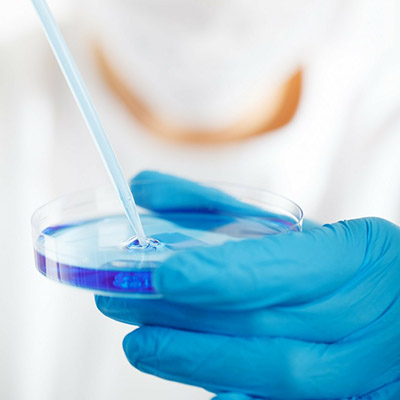 a close up of someone holding a petri dish