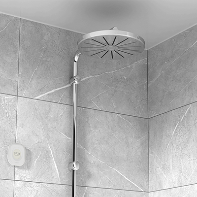 Aguardio Shower Sensor next to a silver showerhead. 