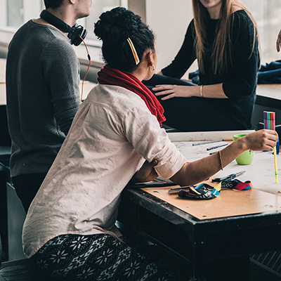 A group of people working at a table. 