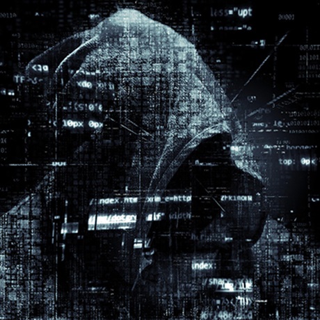 A hooded figure in the background with computer code across the forefront of the image