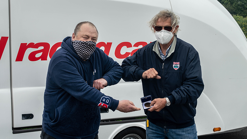 Clive Temple receiving his medal from Adrian Reynard