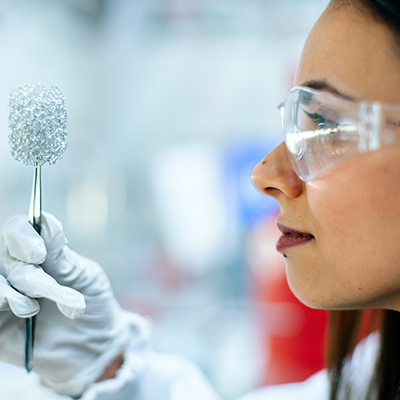 Lab engineer inspecting a clean energy battery