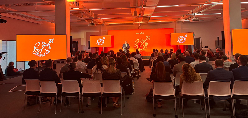a conference room of aviation industry representatives listens to Mike KAne MP speak