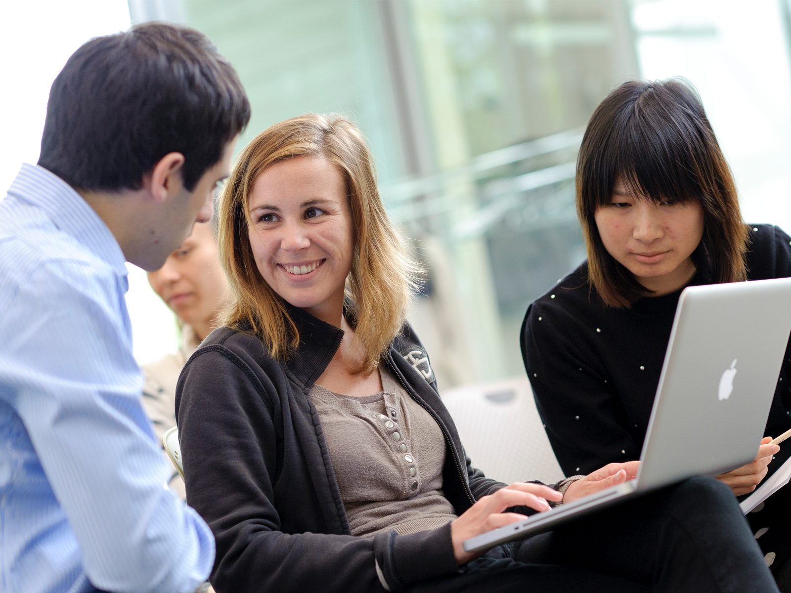 Member of Library staff with student looking at a book