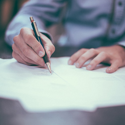 Person filling out forms by hand